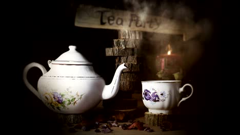 cup of tea and teapot on wooden table with arrow sign, smoke ,candle flame and light in the background. tea party concept