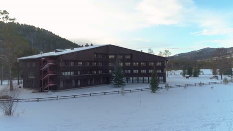 cabin in the mountains with snow on the ground