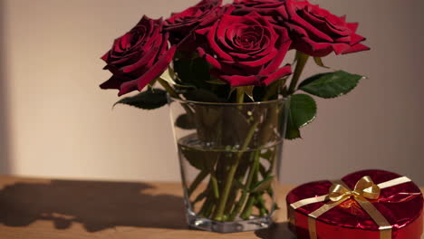 red roses and heart-shaped gift box