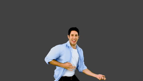 Man-playing-air-guitar-on-grey-background