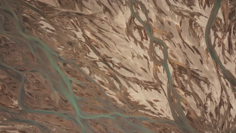 top-down aerial view of river estuary in landmannalaugar, creating abstract patterns