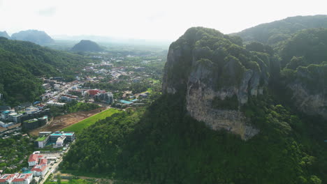 Stunning-limestone-cliffs-with-village-on-base-in-in-Ao-Nang,-Thailand