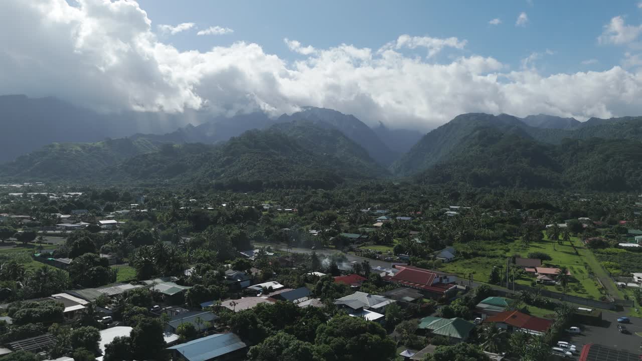 Aerial View of a Tropical Village Nestled in a Lush Mountain Valley