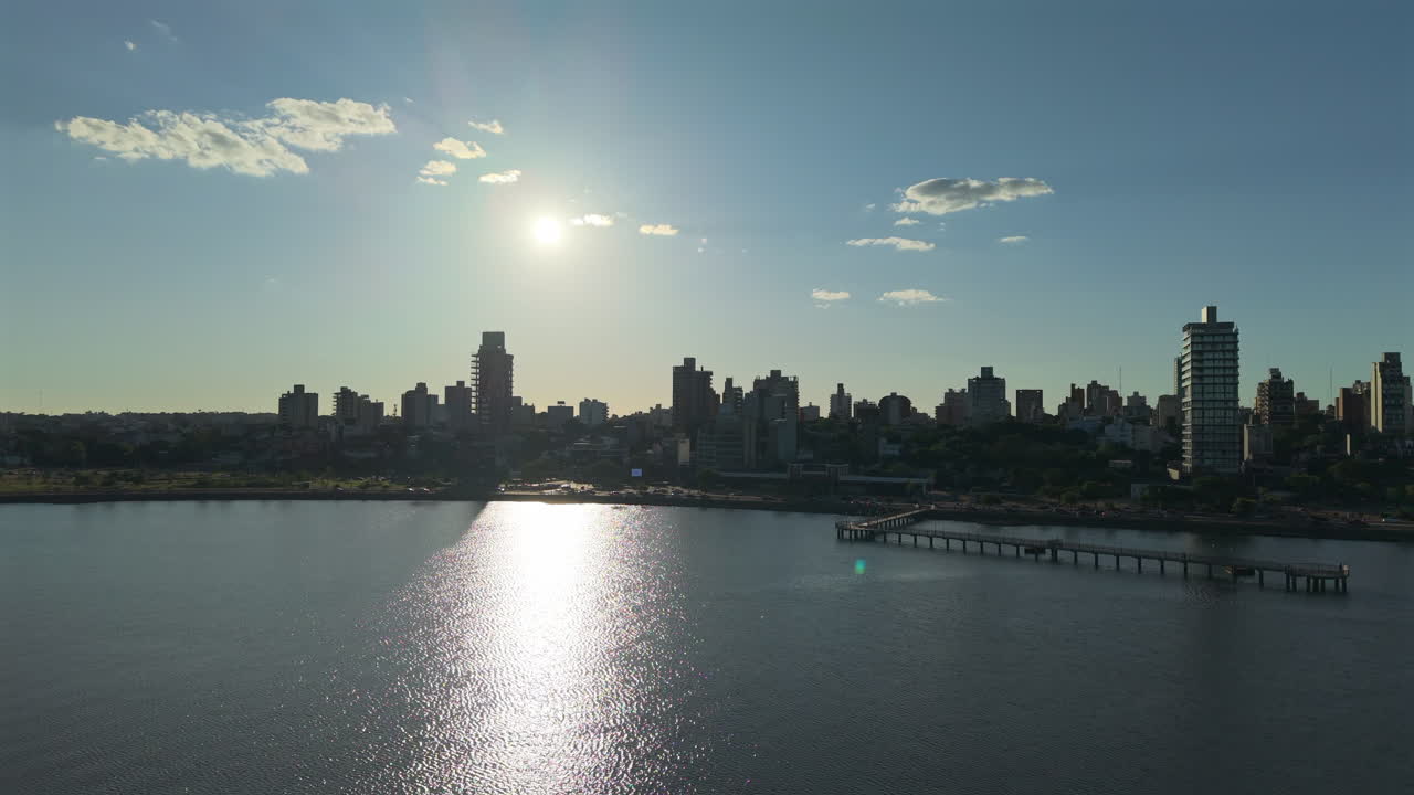 Drone view of Posadas coastline city of Misiones, Argentina sunset landscape, downtown, water reflection