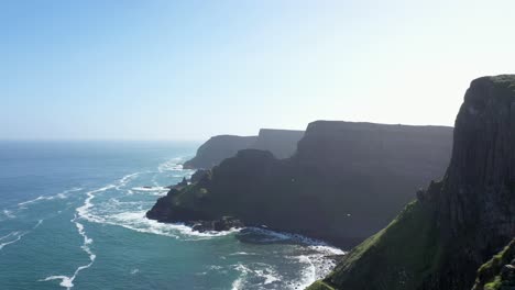 the giants causeway lies at the foot of the basalt cliffs along the sea coast on the north shores of county antrim