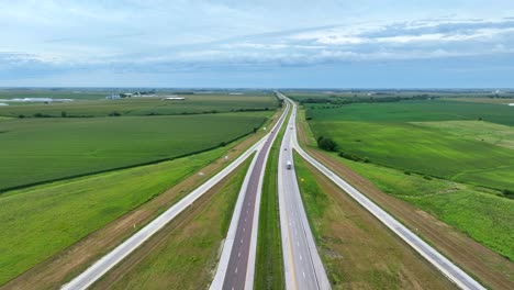 Highway-cutting-through-vast-farmland-in-midwest-USA