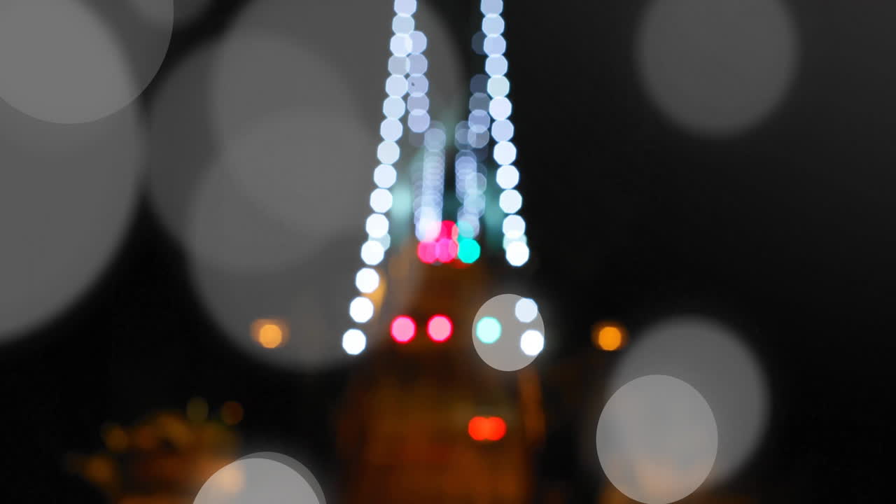 Bokeh lights animation over blurred cityscape at night