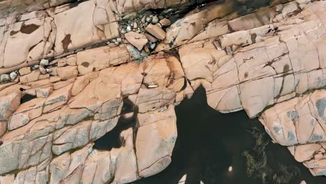 overhead aerial over the rocky shoreline out to sea near lysekil, sweden