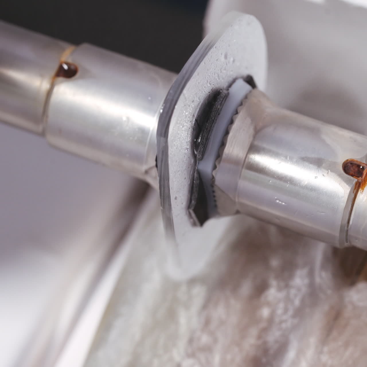 Special optical equipment for making lens. Glass lens spinning on automatic tool. Close-up.