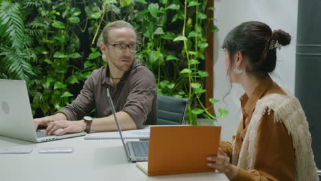 business lady communicating with colleague in trendy coworking office