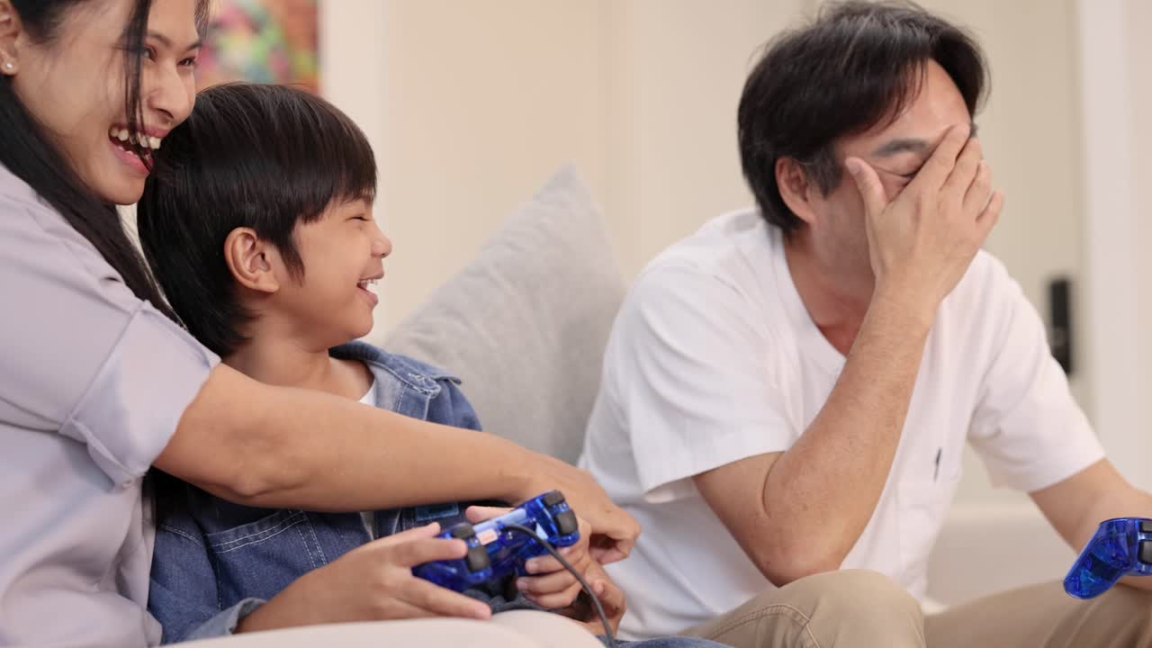 Happy family playing video games together, laughing and bonding in a cozy living room