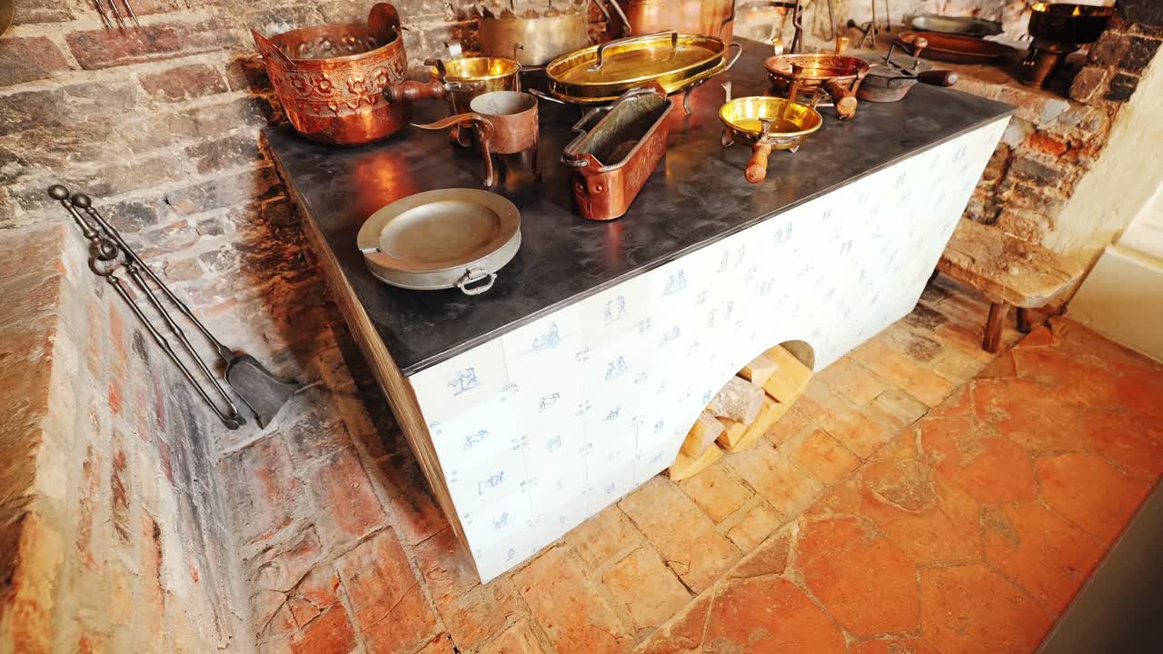 Warm brick textures and antique copper cookware in traditional European kitchen