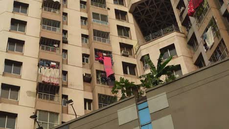 multi-story apartment building with clothes drying on balconies