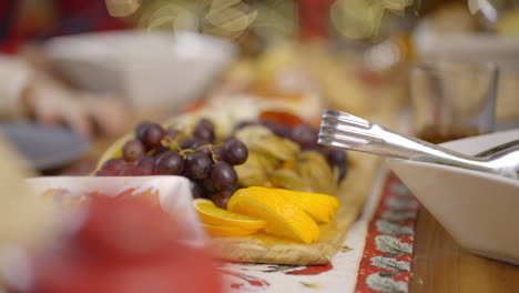 close-up of a fruit platter with hand reaching