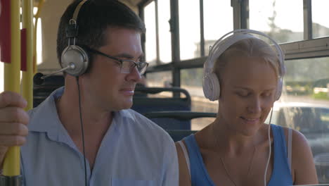 young people listening to music in the bus