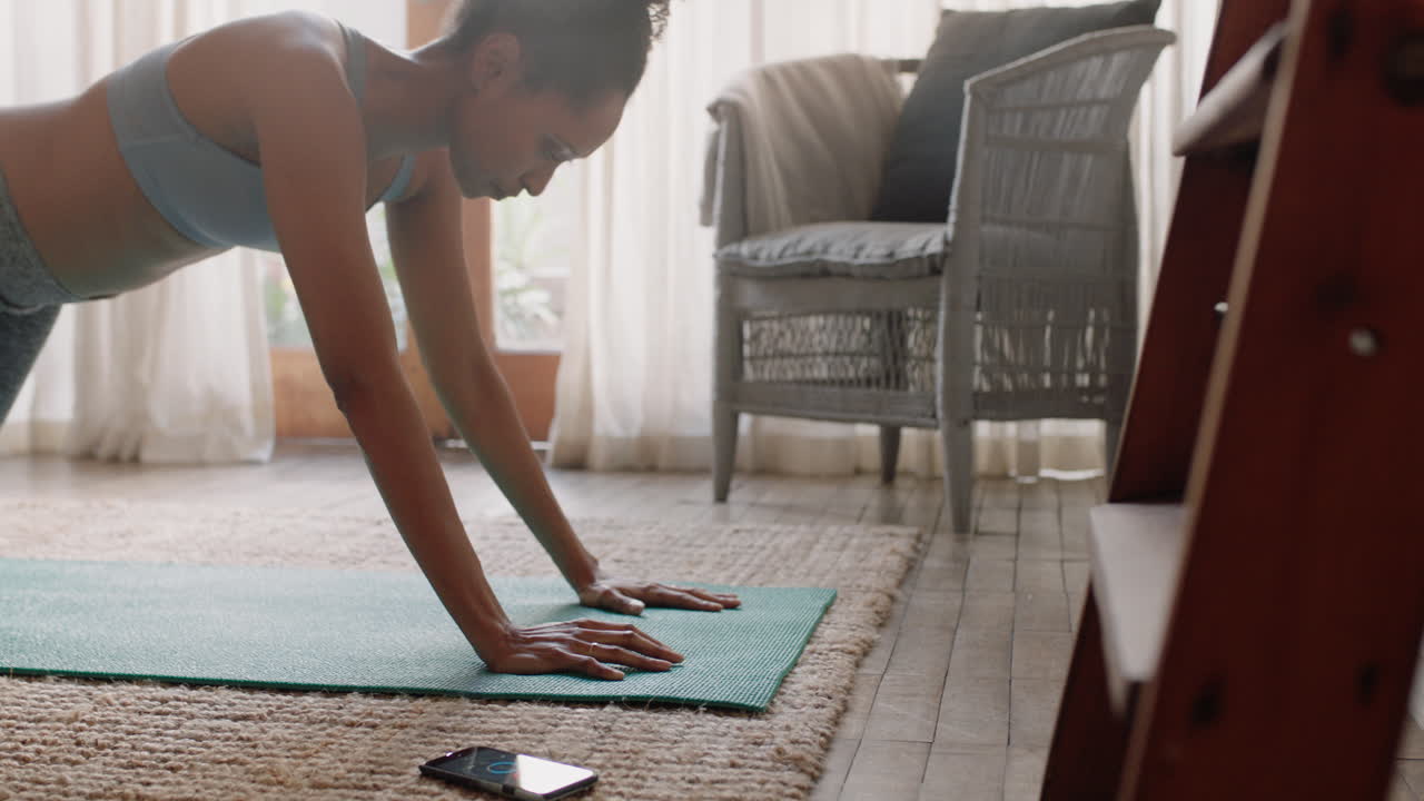 healthy woman exercising at home practicing push ups in living room enjoying morning fitness workout