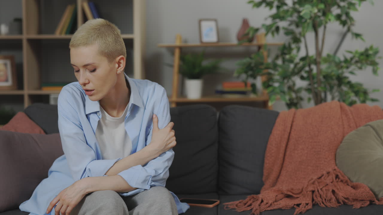Woman Sitting on Sofa, Thoughtful Expression