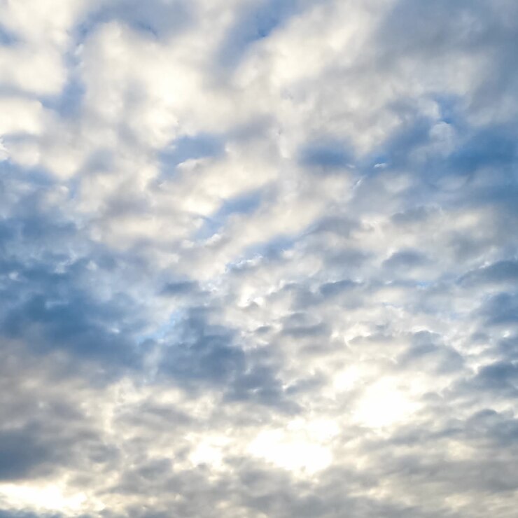 Movement of fluffy clouds along the horizon. Spindrift cloudscape covering the skies and shielding the sun. Timelapse