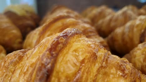 close up of delicious freshly baked golden brown croissants in local bakery and cake shop