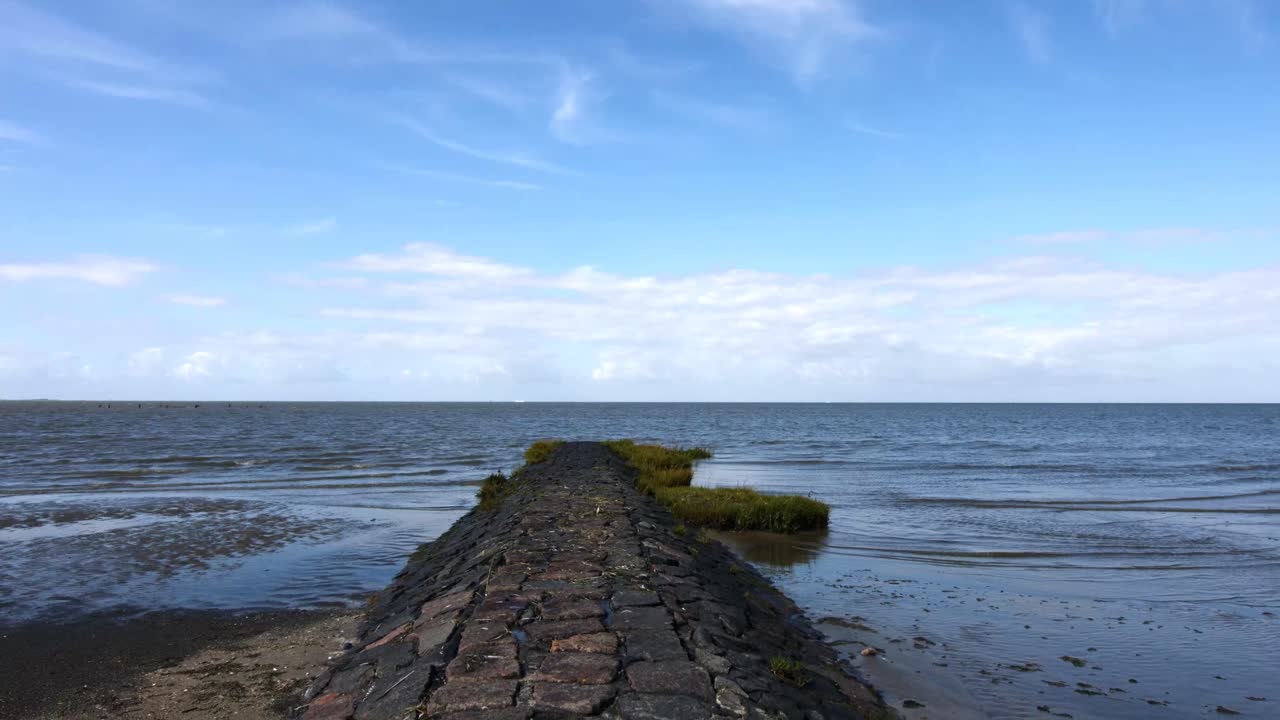 camera tilt showing a stone path leading into the north sea
