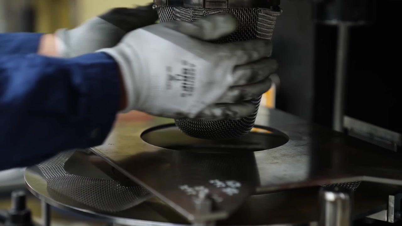 Hydraulic press machine stamping a stainless steel disc into a bowl shaped mold