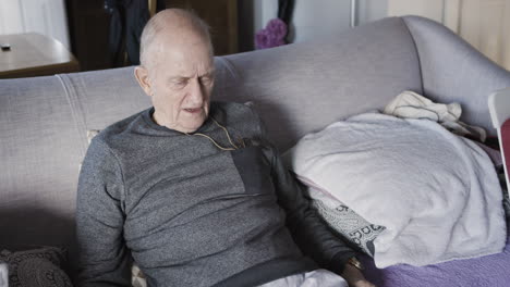 elderly man resting on couch