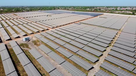 flying over new solar panels at photovoltaic power plant under construction. renewable electric energy