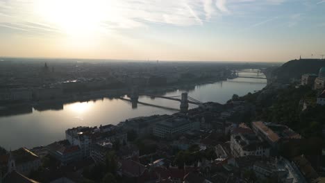 Cinematic-Establishing-Drone-Shot-Above-Danube-River-in-Budapest-at-Sunrise