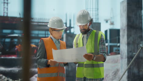 engineers or architects reviewing blueprints on a construction site