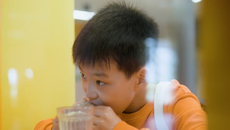 schoolboy eating and drinking.