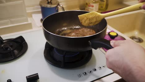 person flipping over a4 wagyu steak cooking in the frying pan