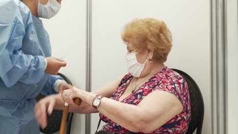 medical professional giving a vaccine shot to an elderly patient, highlighting the importance of vaccination