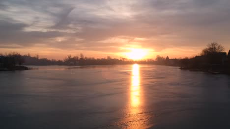 sunrise at an icey lake with small islands in winter drone footage recorded with a dji spark 1080p 30fps