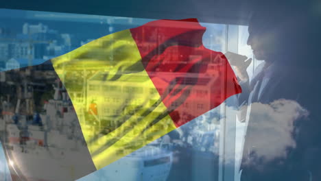 Romanian flag animation over businessperson looking out office window at cityscape
