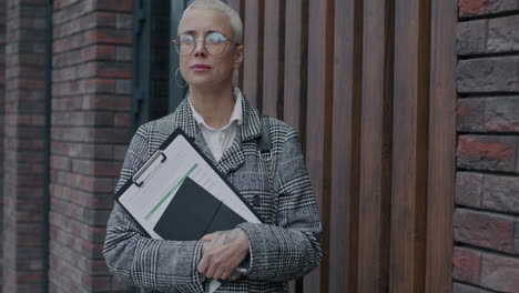 businesswoman holding documents outside