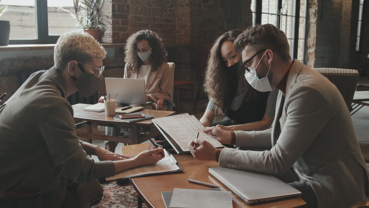 Young Coworking Team Discussing Business Documents