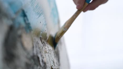 close up of artist paints picture creates abstract modern art close up of artist paints picture creates abstract modern art on white canvas