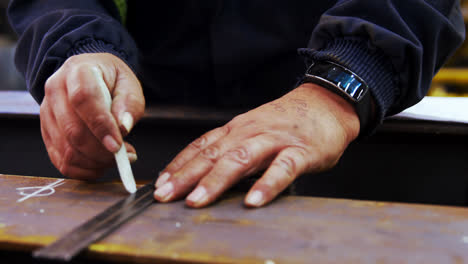 Male-engineer-measuring-a-metal-in-workshop-4k