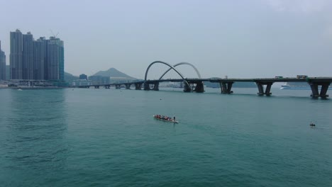 dragon boat team rowing to the pace of an onboard drummer, aerial view