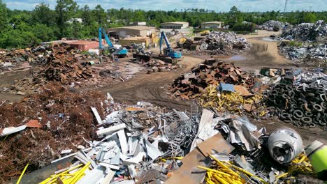 rising-drone-view-of-scrapyard-on-a-bright-sunny-day