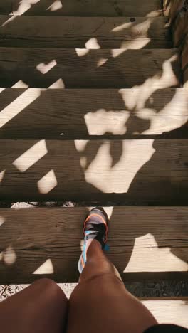 person walking up wooden stairs