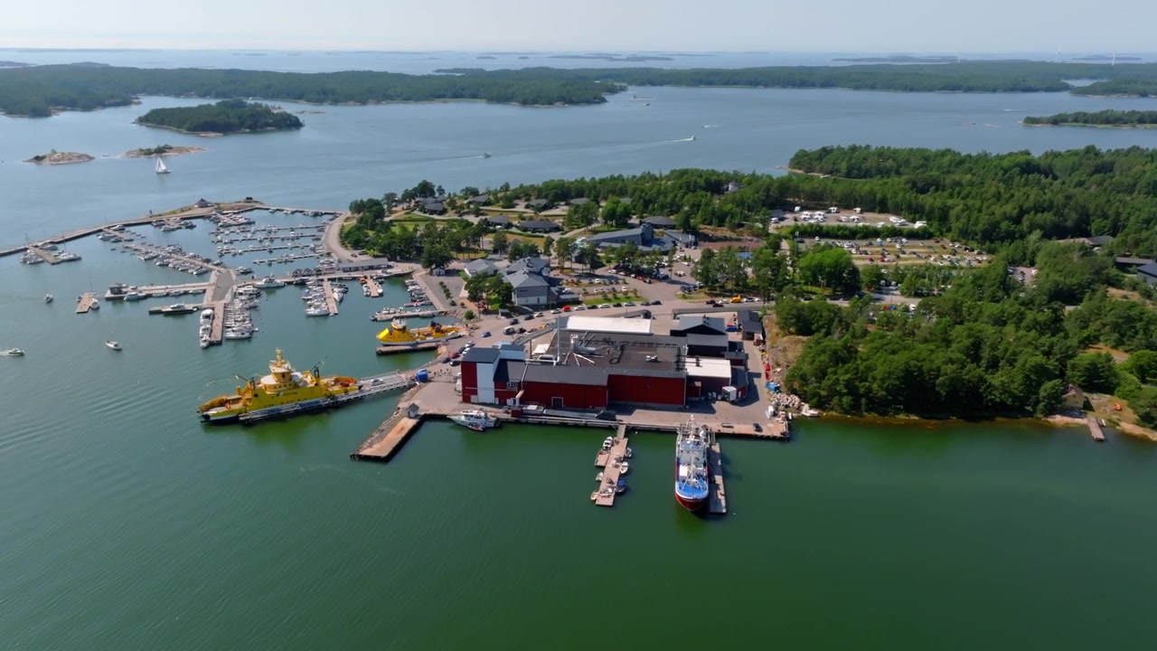 Vista aerea che si avvicina alla fabbrica di pesce e al porto turistico di Kasnas, estate in Finlandia