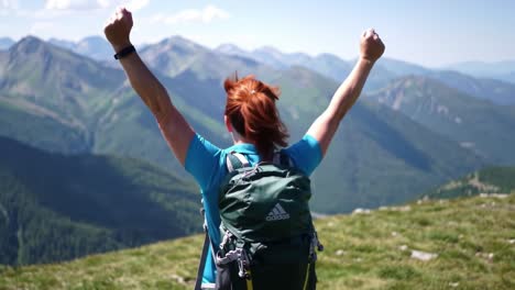 a hiker celebrates the joy of reaching the summit amidst majestic mountain scenery, embracing nature's beauty after a rewarding trek