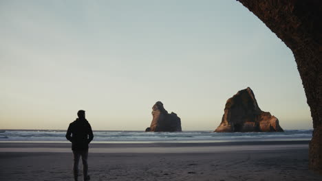 man contemplating the ocean at sunset