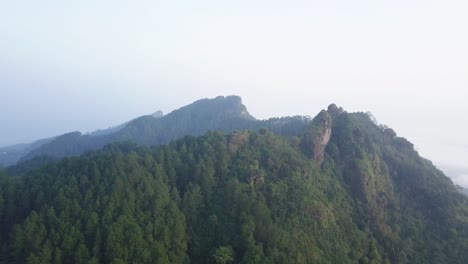 drone panoramic shot of green summit of menoreh hill during cloudy day in indonesia