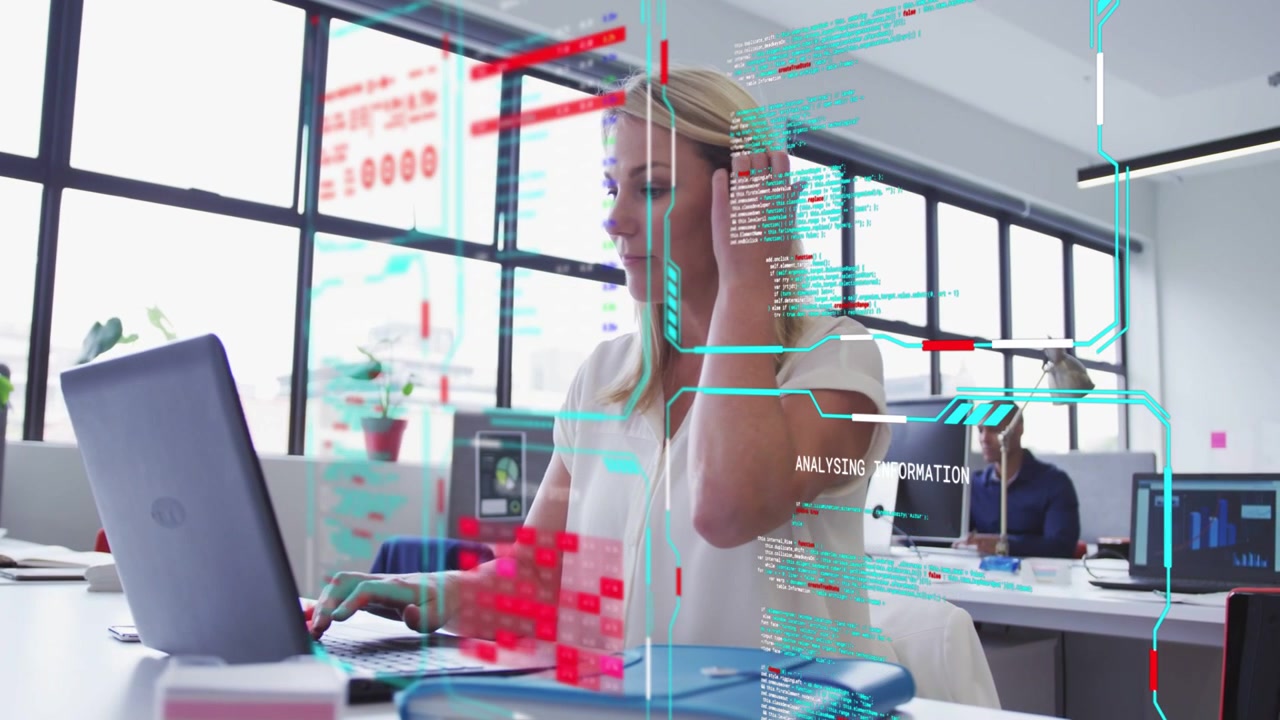 Woman typing on laptop in business office, causing animated teal and red HUD analyzing sales data