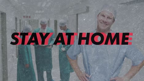 Stay-at-home-and-be-safe-text-against-portrait-of-male-health-worker-smiling-in-corridor-at-hospital