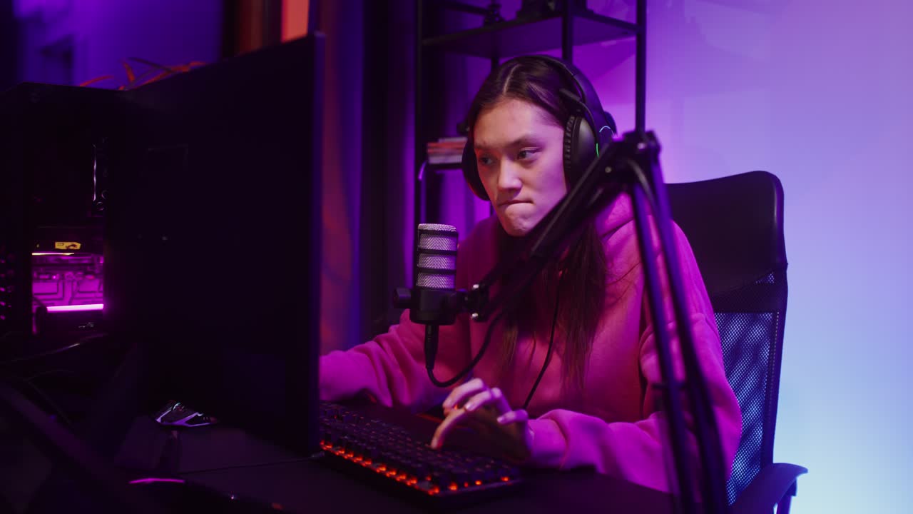 Woman Gaming and Streaming with Computer and Microphone