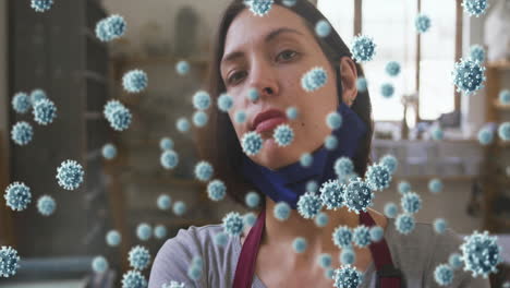 composite video of covid-19 cells floating against female caucasian potter smiling