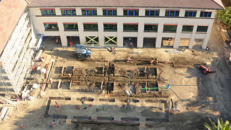 aerial view of an active construction site with building development and earthwork